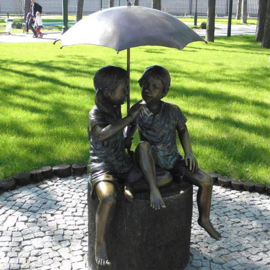 Boy and girl sitting unde umbrella bronze garden decor